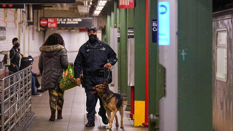 Police officers patrol a subway station in New York, Tuesday, April 12, 2022. Multiple people were shot and injured Tuesday at a subway station in New York City during a morning rush hour attack that left wounded commuters bleeding on a train platform. (AP Photo/Seth Wenig)