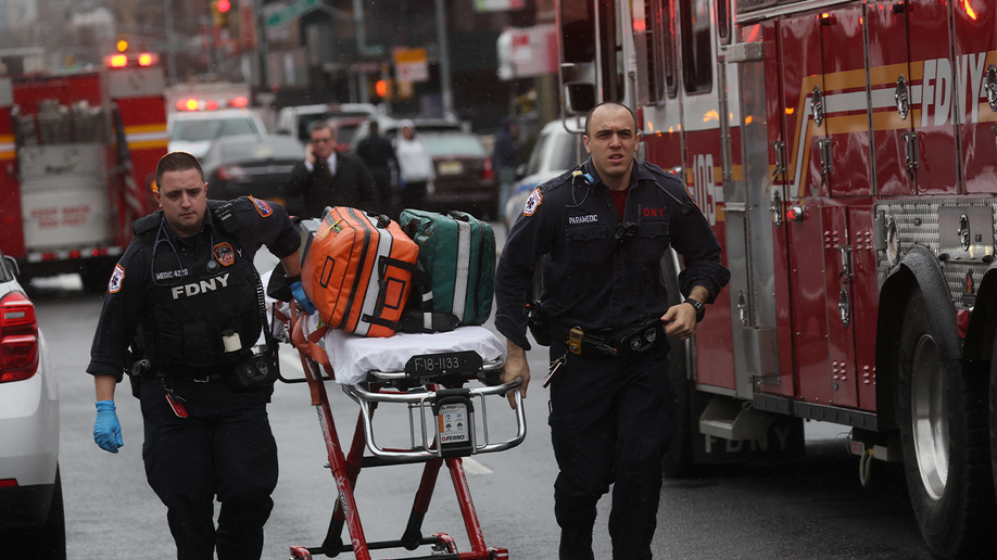 first responders with stretcher outside subway station in New York