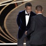 Will Smith (R) hits Chris Rock as Rock spoke on stage during the 94th Academy Awards in Hollywood, Los Angeles, California.