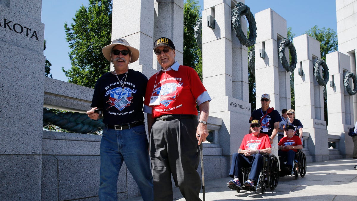World War II veterans are escorted towards a ceremony at the National World War II Memorial marking the 70th anniversary of the D-Day invasion of Europe on June 6, 1944, while in Washington, June 6, 2014.