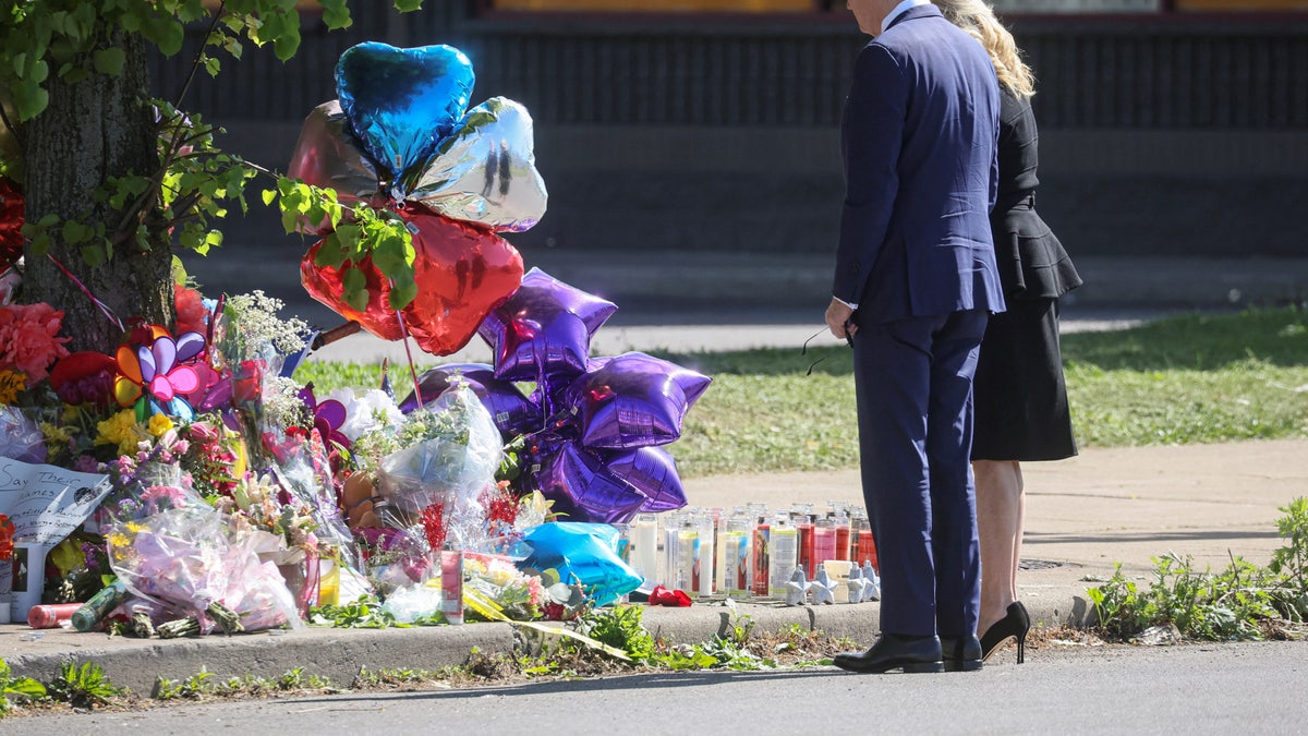 U.S. President Joe Biden and first lady Jill Biden look at a memorial in the wake of a weekend shooting at a Tops supermarket in Buffalo, New York, U.S. May 17, 2022.