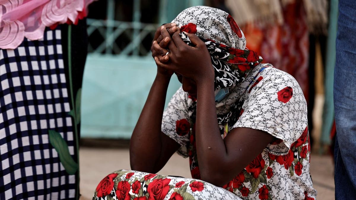 Diali Kaba sits and cries outside Mame Abdou Aziz Sy Dabakh hospital