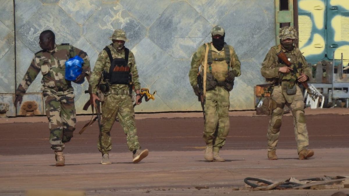 This undated photograph handed out by French military shows three Russian mercenaries, right, in northern Mali. Russia has engaged in under-the-radar military operations in at least half a dozen countries in Africa in the last five years using a shadowy mercenary force analysts say is loyal to President Vladimir Putin. The analysts say the Wagner Group of mercenaries is also key to Putin's ambitions to re-impose Russian influence on a global scale. 