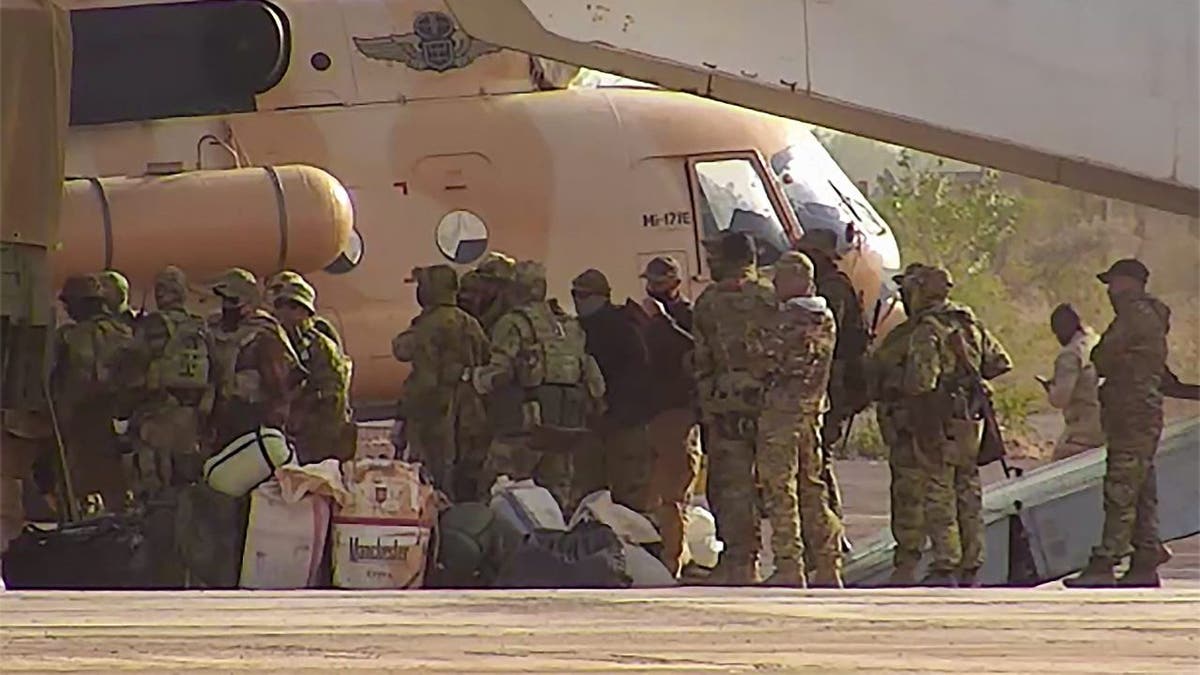 This undated photograph handed out by French military shows Russian mercenaries boarding a helicopter in northern Mali. 