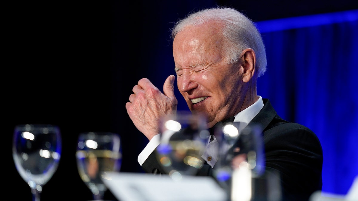 President Joe Biden laughs as he listens to Trevor Noah, host of Comedy Central's "The Daily Show," speak at the annual White House Correspondents' Association dinner, Saturday, April 30, 2022, in Washington. (AP Photo/Patrick Semansky)