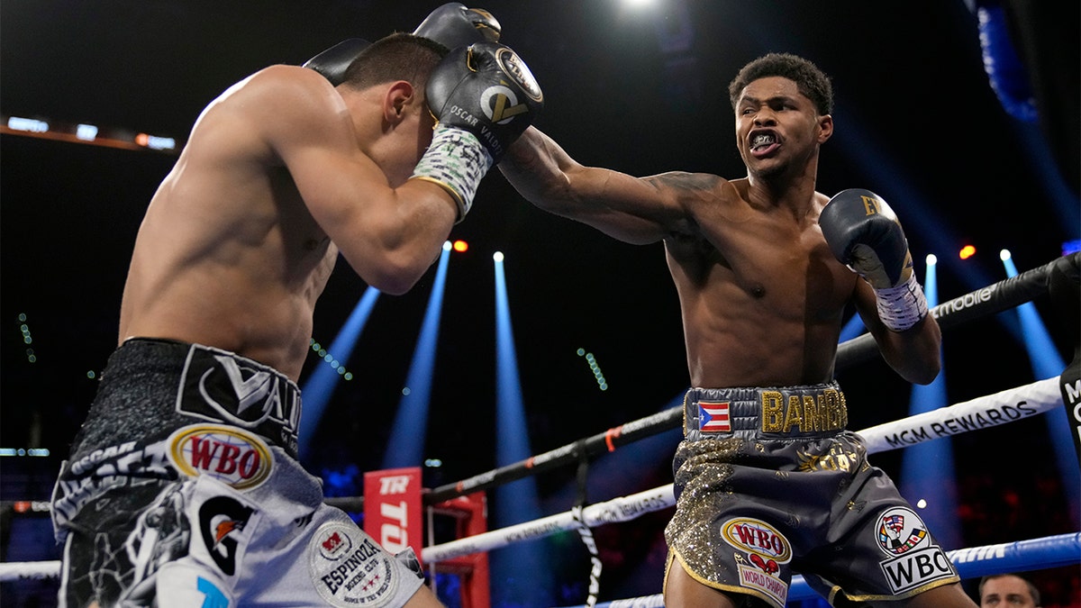 Shakur Stevenson, right, throws a punch at Oscar Valdez during a WBC-WBO junior lightweight title boxing bout Saturday, April 30, 2022, in Las Vegas.