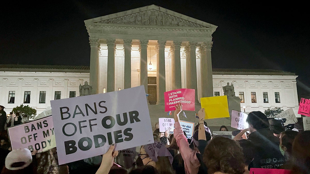 A crowd of people gather outside the Supreme Court, Monday night, May 2, 2022 in Washington following reports of a leaked draft opinion by the court overturning Roe v. Wade.?