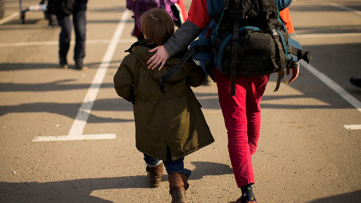 People who fled from Mariupol and other towns arrive to a reception center for displaced people in Zaporizhzhia, Ukraine, Tuesday, May 3, 2022.