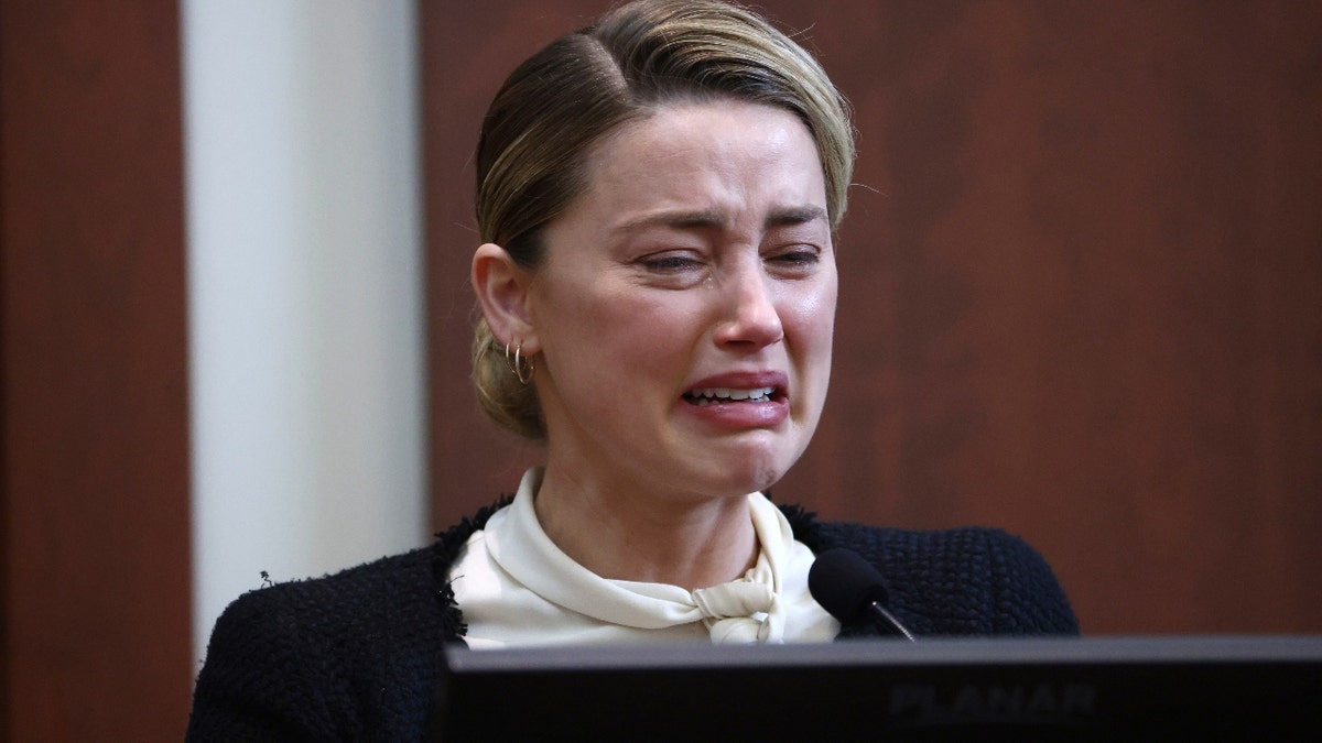 Amber Heard reacts as she testifies 