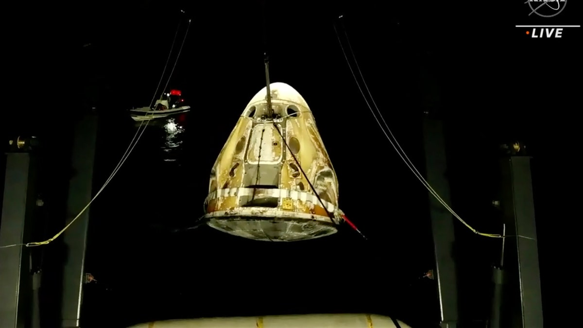 In this image made from video supplied by NASA, SpaceX Dragon space capsule is lifted out of the water after splashing down in the Gulf of Mexico early Friday, May 6, 2022. (NASA via AP)