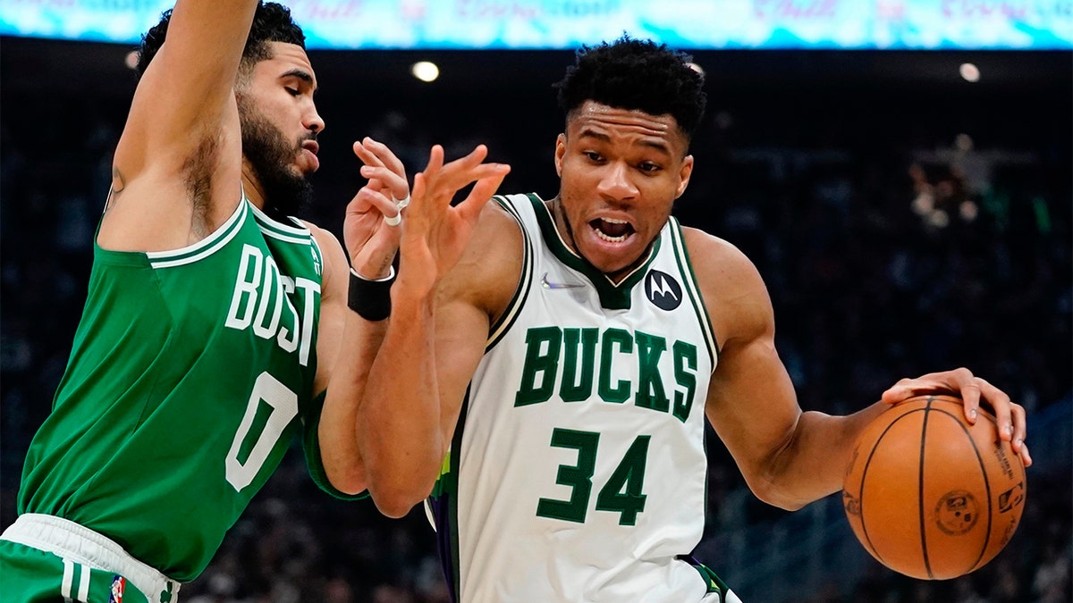 Milwaukee Bucks' Giannis Antetokounmpo gets past Boston Celtics' Jayson Tatum during the first half of Game 3 of an NBA basketball Eastern Conference semifinals playoff series Saturday, May 7, 2022, in Milwaukee. 
