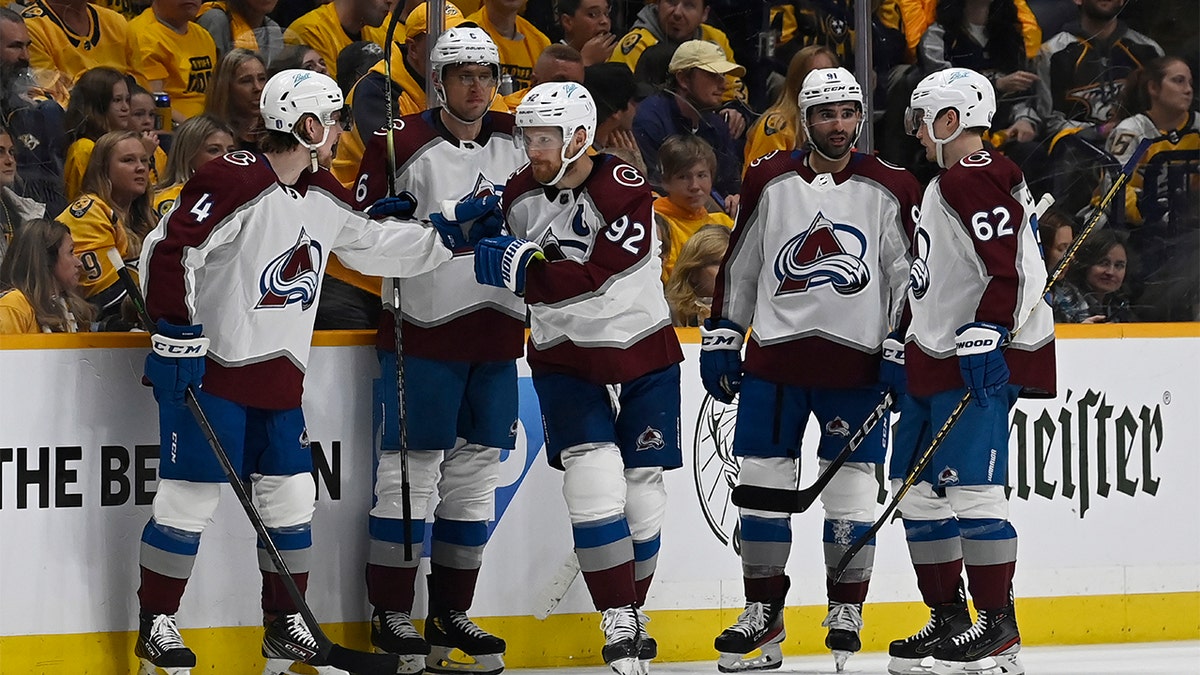 Colorado Avalanche left wing Gabriel Landeskog (92) is congratulated after scoring his third goal of the game during the second period in Game 3 of an NHL hockey Stanley Cup first-round playoff series against the Nashville Predators Saturday, May 7, 2022, in Nashville, Tenn.