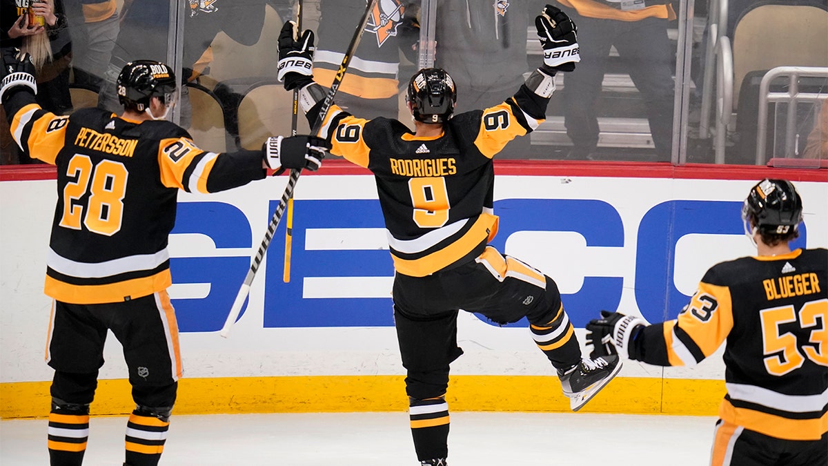 Pittsburgh Penguins' Evan Rodrigues (9) celebrates his second goal of the first period in Game 3 of an NHL hockey Stanley Cup first-round playoff series against the New York Rangers in Pittsburgh, Saturday, May 7, 2022.
