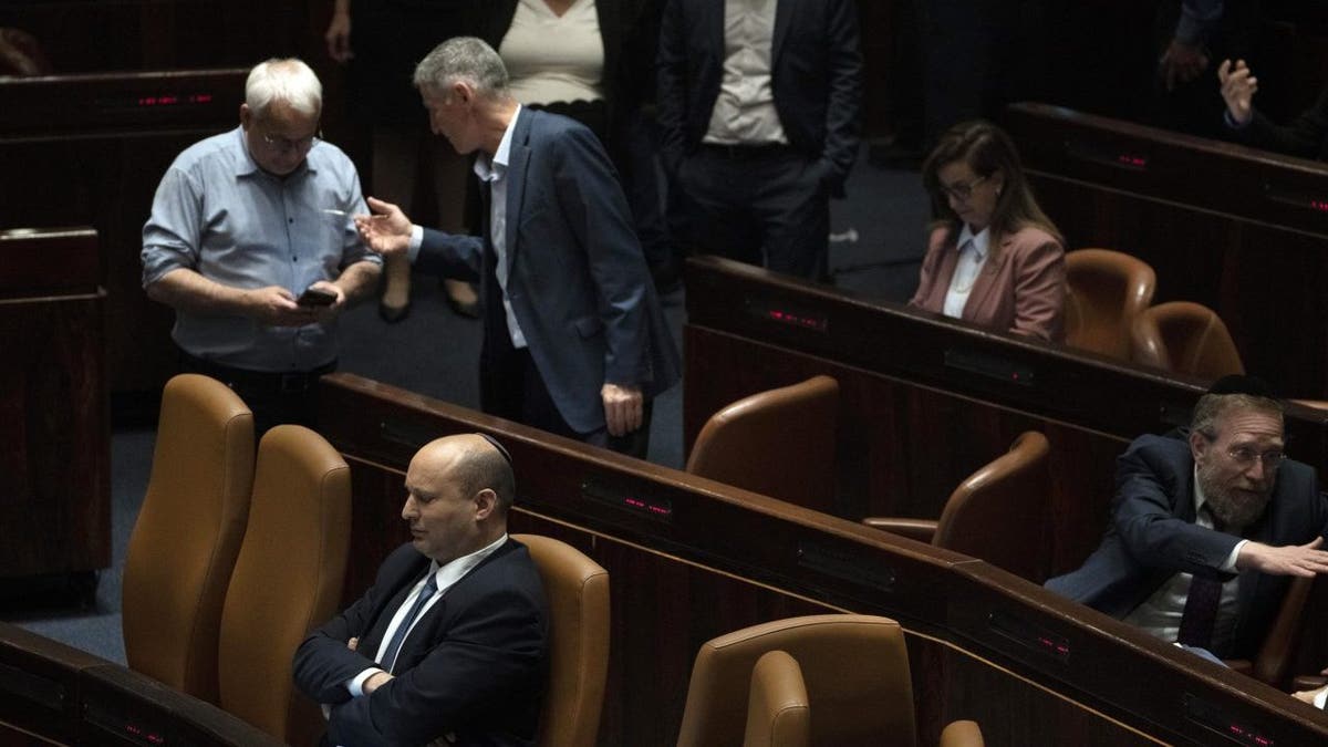 Israeli Prime Minister Naftali Bennett, lower left pauses during the opening of the summer session of the Knesset, Israel's parliament, in Jerusalem, Monday, May 9, 2022. 