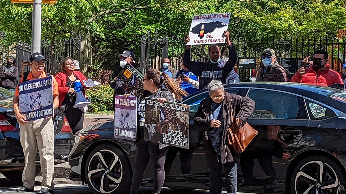 Demonstrators stand outside Manhattan federal court to protest former Honduran President Juan Orlando Hernandez who appeared in court on drug trafficking and weapons charges, Tuesday, May 10, 2022, in New York.