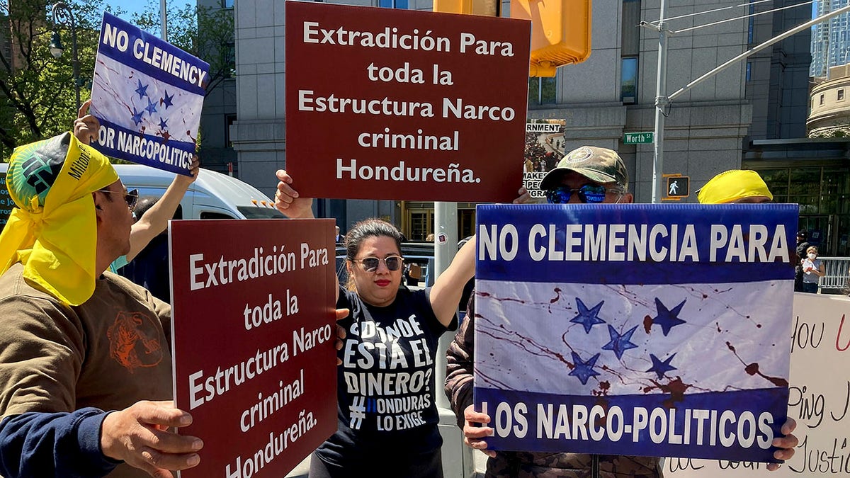 Demonstrators stand outside Manhattan federal court to protest former Honduran President Juan Orlando Hernandez, who pleaded not guilty to charges that he received millions of dollars from 2004 to 2022 to support a drug trade that delivered hundreds of thousands of kilos of drugs to the U.S., Tuesday, May 10, 2022, in New York. 