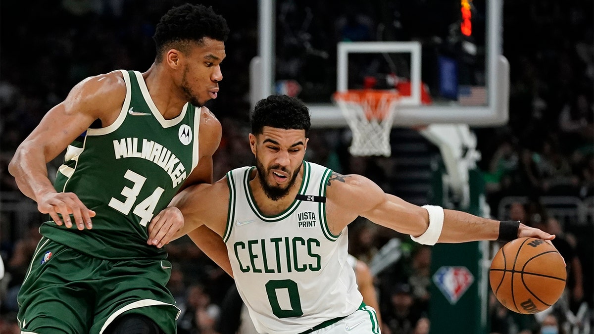Boston Celtics' Jayson Tatum tries to get past Milwaukee Bucks' Giannis Antetokounmpo during the second half of Game 6 of an NBA basketball Eastern Conference semifinals playoff series Friday, May 13, 2022, in Milwaukee. The Celtics won 108-95 to tie the series at 3-3. 