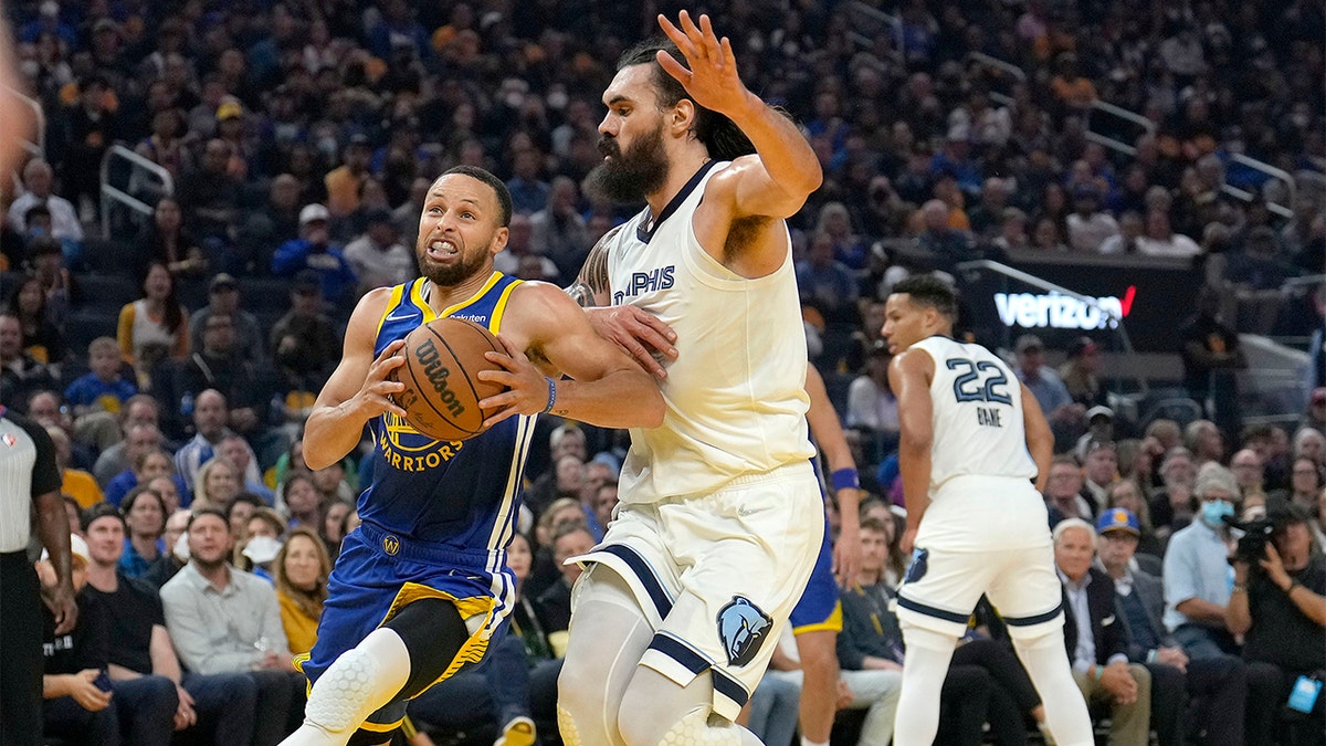 Golden State Warriors guard Stephen Curry drives to the basket against Memphis Grizzlies center Steven Adams during the first half of Game 6 of an NBA basketball Western Conference playoff semifinal in San Francisco, Friday, May 13, 2022.?