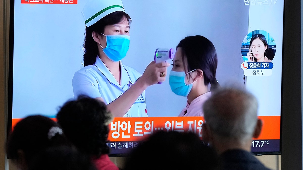 People watch a TV screen showing a news report about the COVID-19 outbreak in North Korea, at a train station in Seoul, South Korea, Saturday, May 14, 2022. (AP Photo/Ahn Young-joon)