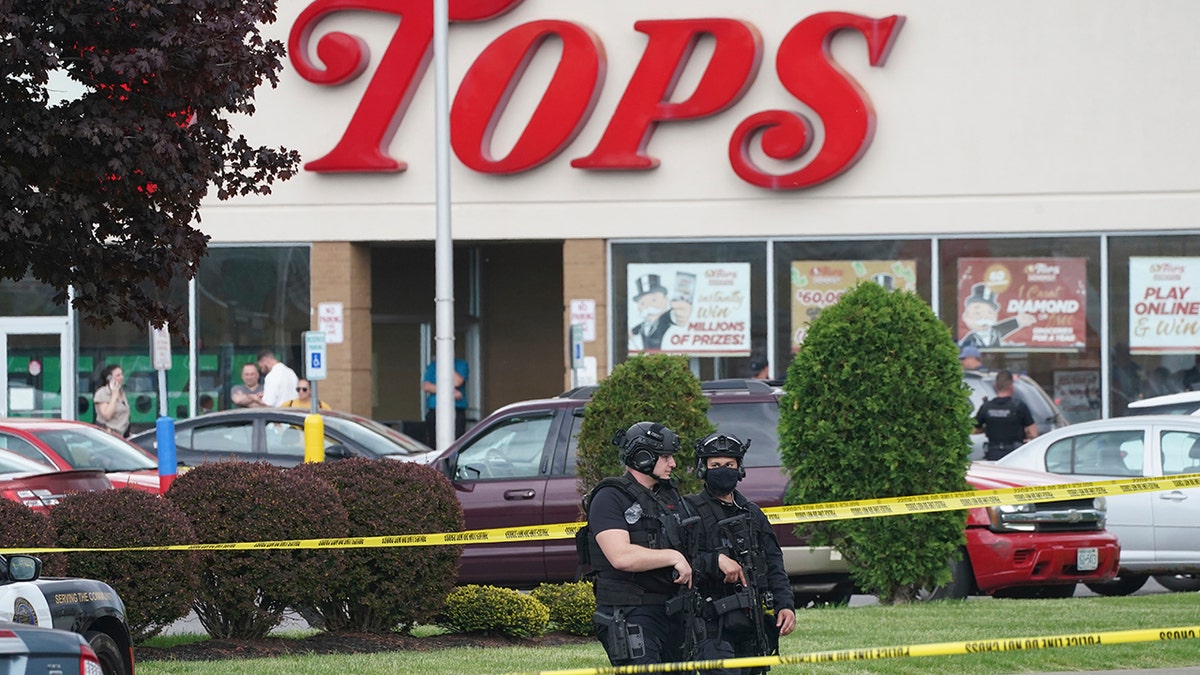 Police secure an area around a supermarket where several people were killed in a shooting, Saturday, May 14, 2022 in Buffalo, N.Y. Officials said the gunman entered the supermarket with a rifle and opened fire. Investigators believe the man may have been livestreaming the shooting and were looking into whether he had posted a manifesto online (Derek Gee/The Buffalo News via AP)