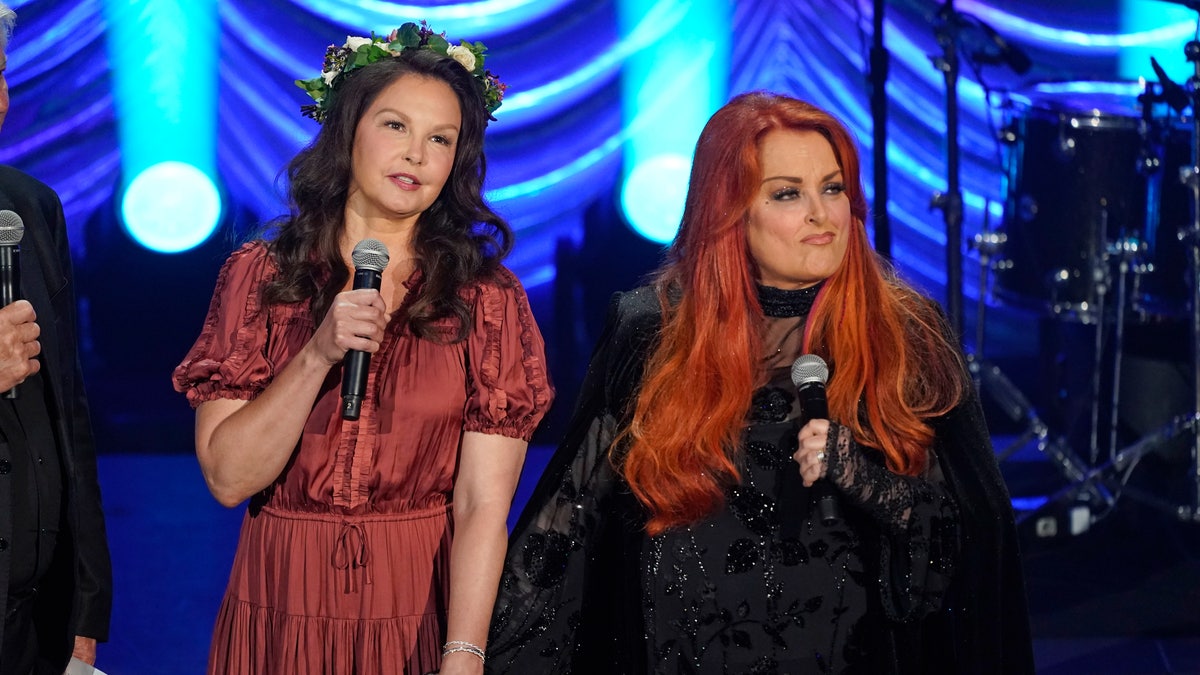 Ashley Judd, left, and Wynonna Judd speak during a tribute to their mother, country music star Naomi Judd, Sunday, May 15, 2022, in Nashville, Tenn. Naomi Judd died April 30. She was 76. (AP Photo/Mark Humphrey)