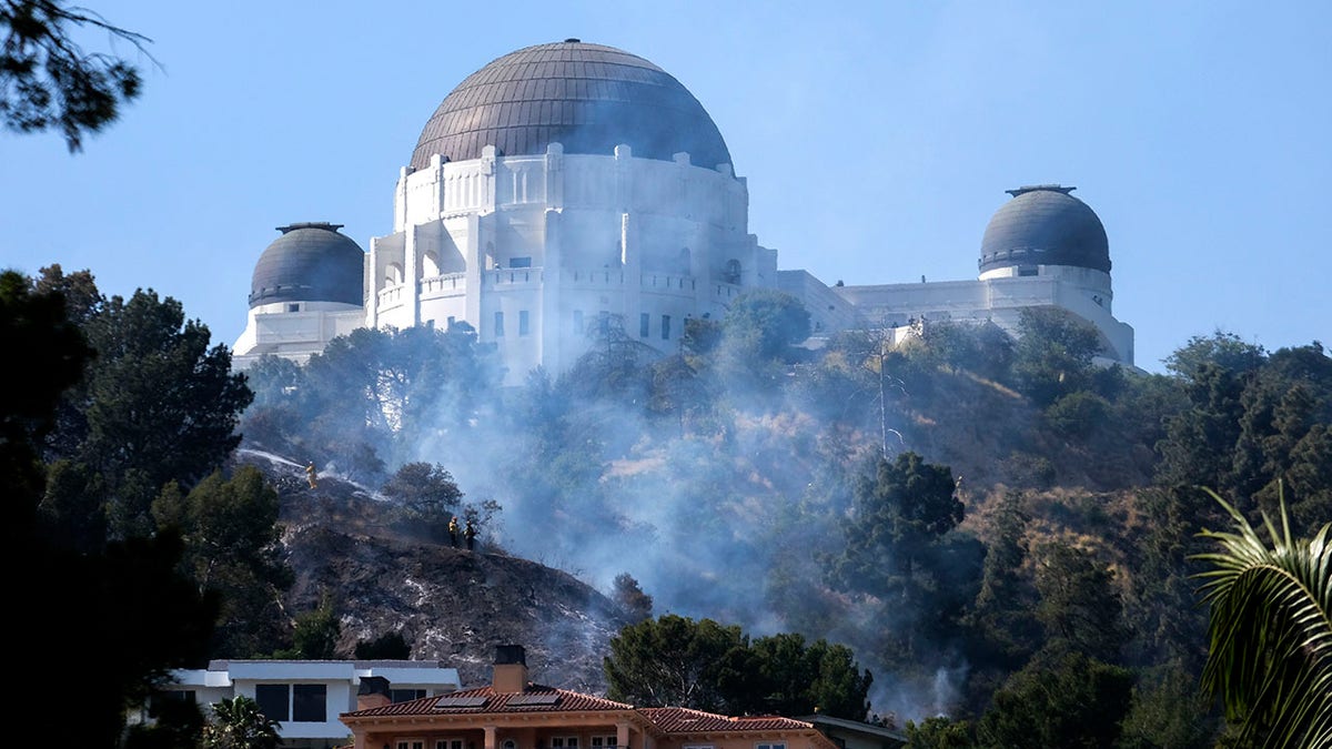 Smoke rises from brush near Griffith Observatory near Los Angeles