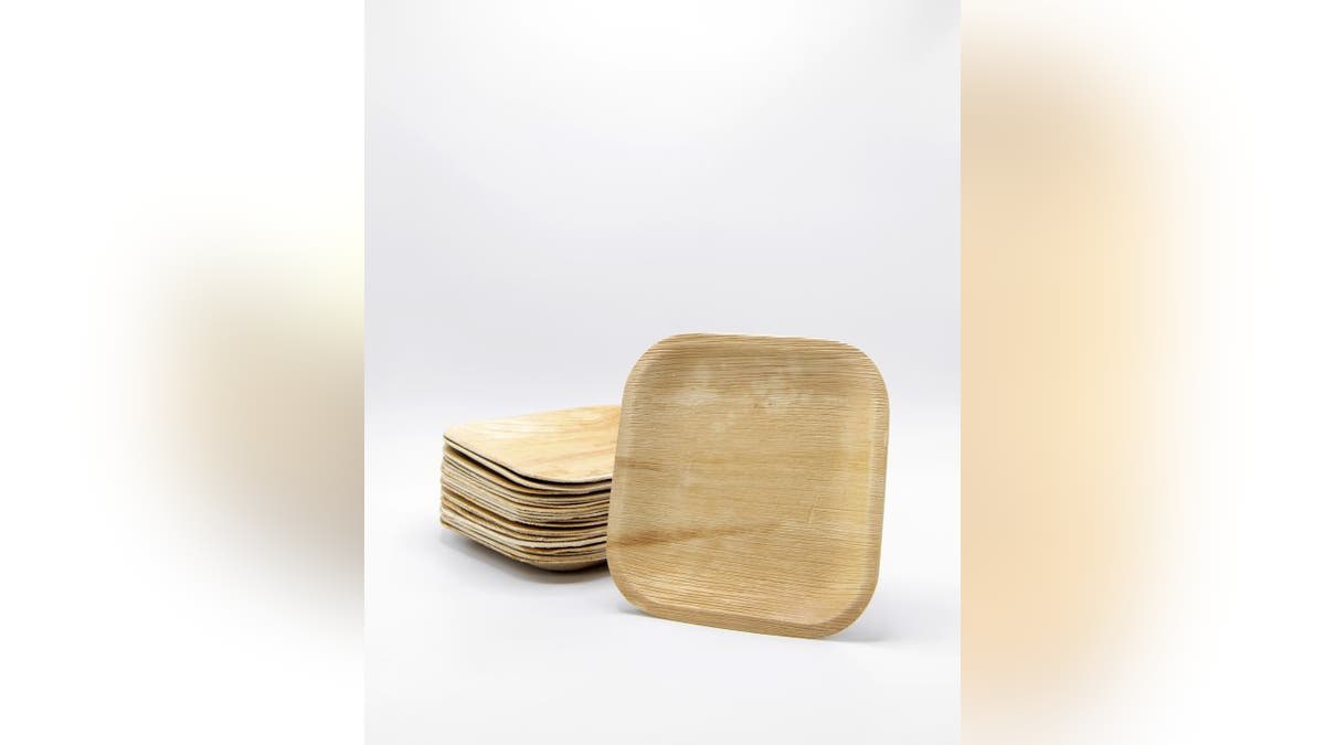 A stack of palm leaf plates from VerTerra sit on a surface