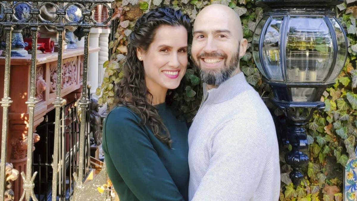 Kate Winick and Sean Ir hug each other in a posed outdoor photo