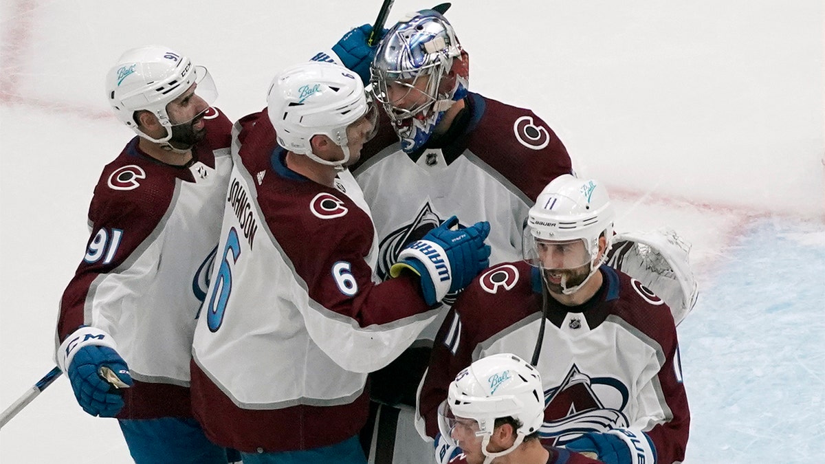 Colorado Avalanche goaltender Darcy Kuemper celebrates with teammates Nazem Kadri (91), Erik Johnson (6) and Andrew Cogliano (11) following a 5-2 victory over the St. Louis Blues in Game 3 of an NHL hockey Stanley Cup second-round playoff series Saturday, May 21, 2022, in St. Louis.