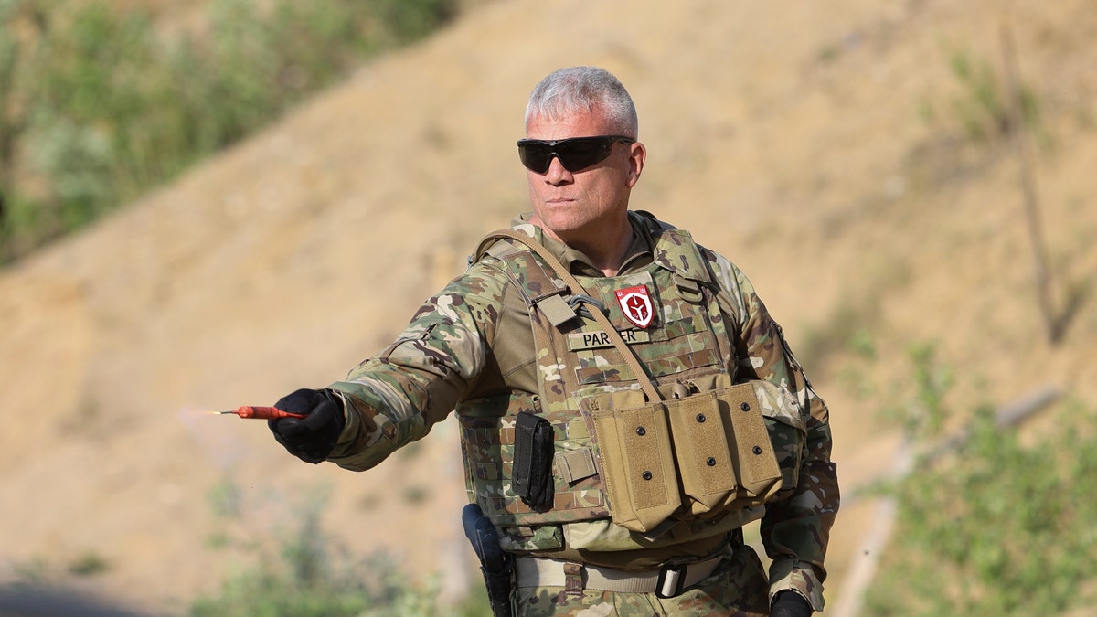 US Veteran holds smoke grenade