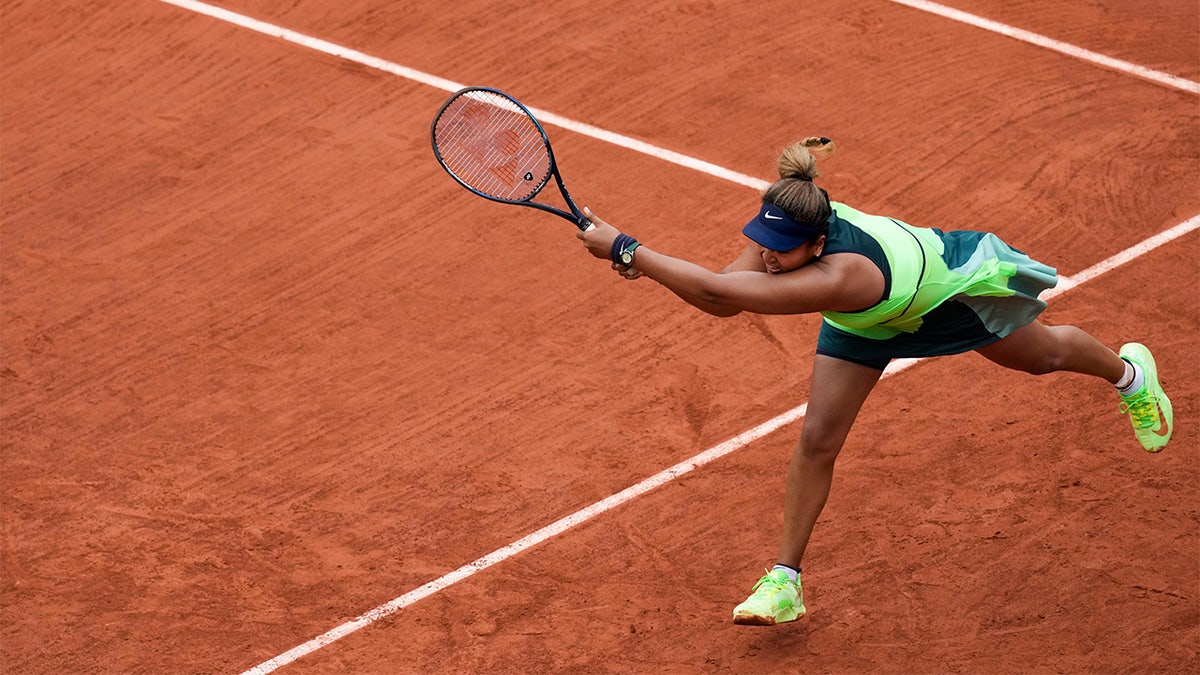 Japan's Naomi Osaka plays a shot against Amanda Anisimova of the U.S. during their first round match at the French Open tennis tournament in Roland Garros stadium in Paris, France, Monday, May 23, 2022. 