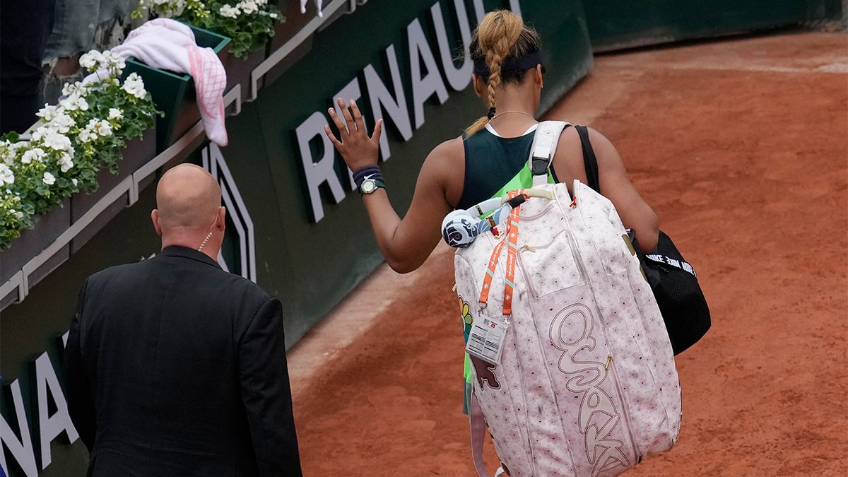 Japan's Naomi Osaka leaves after losing against Amanda Anisimova of the U.S. during their first round match at the French Open tennis tournament in Roland Garros stadium in Paris, France, Monday, May 23, 2022. 