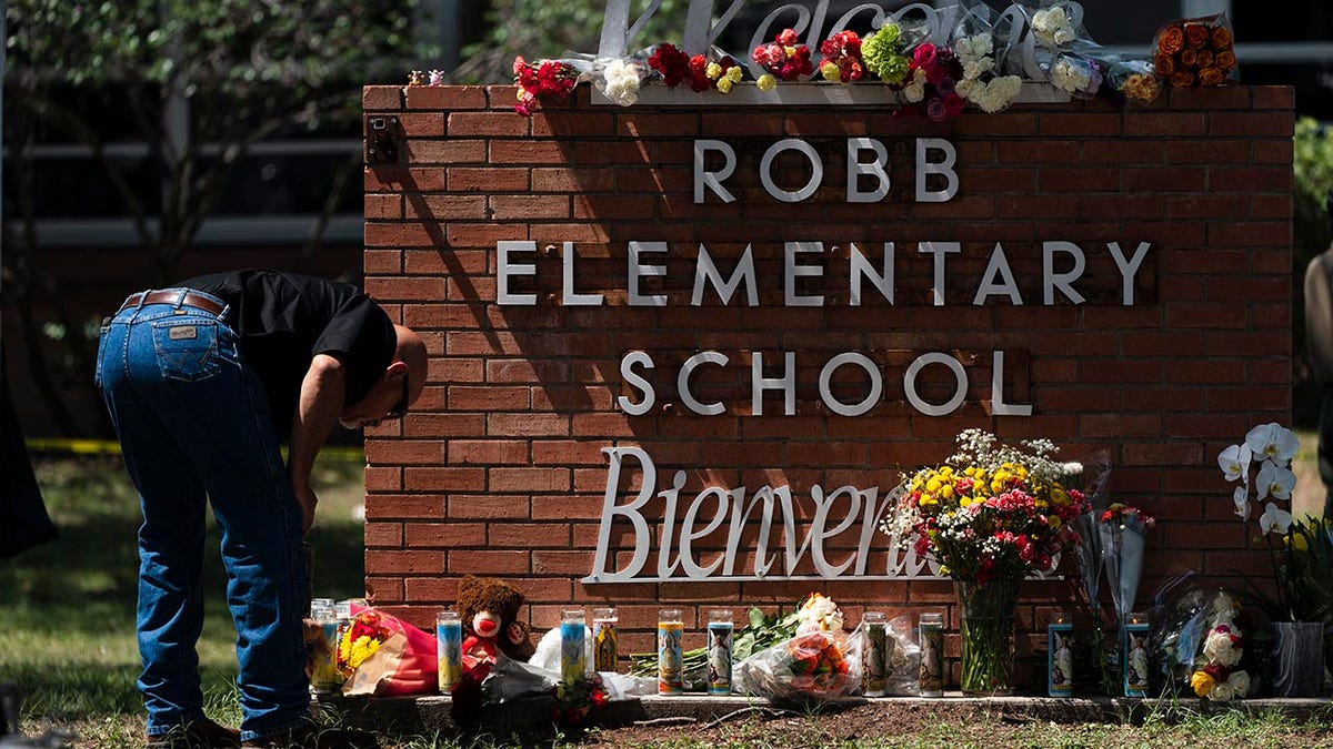 People lay flowers at Robb Elementary Uvalde, Texas