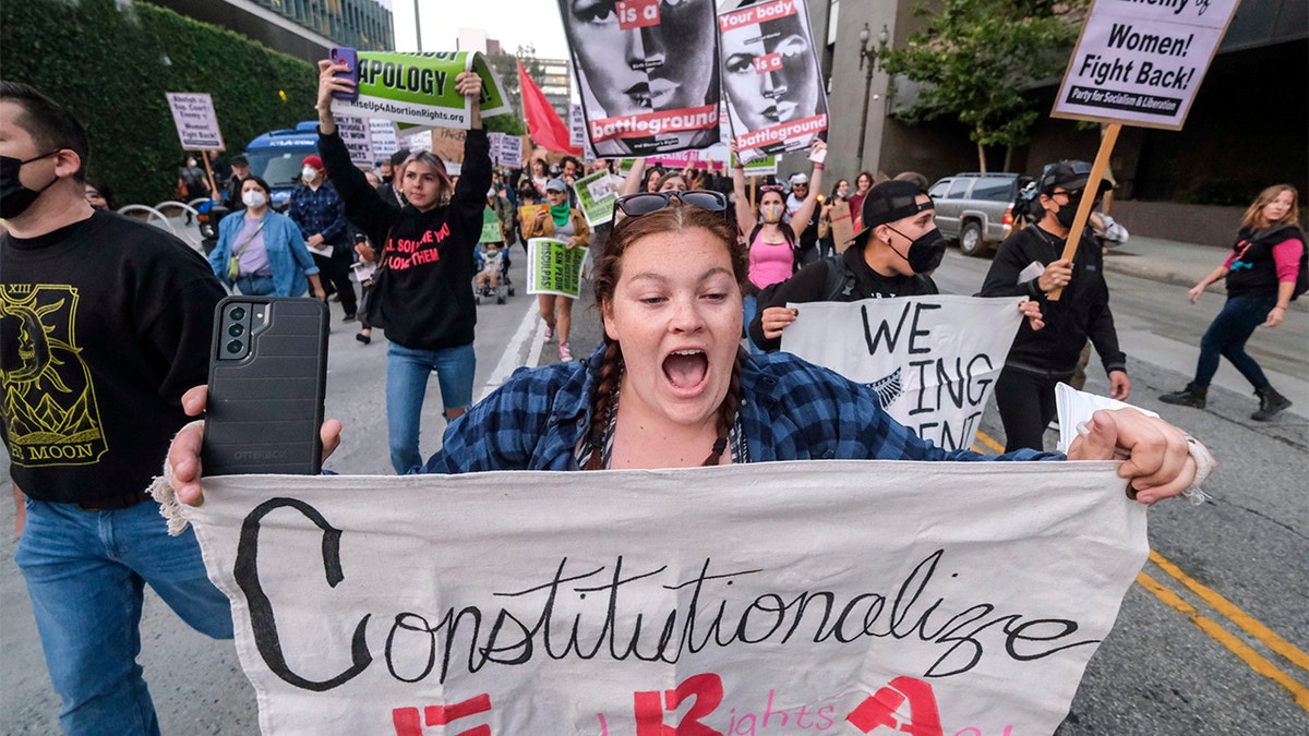 Demonstrators march down the streets after protesting outside of the U.S. Courthouse in response to a leaked draft of the Supreme Court's opinion to overturn Roe v. Wade, in Los Angeles, Tuesday, March 3, 2022. (AP Photo/Ringo H.W. Chiu)