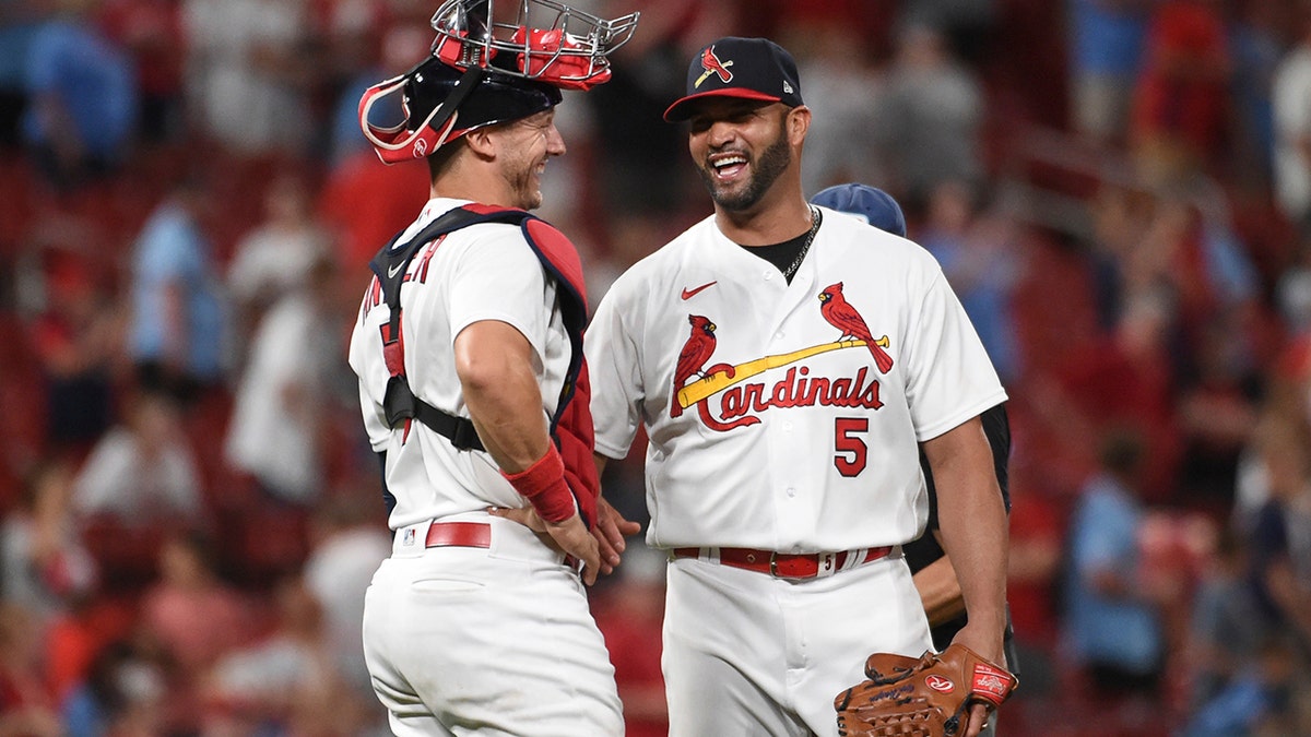 St. Louis Cardinals catcher Andrew Knizner (7) and teammate Albert Pujols celebrate their team's 15-6 victory over the San Francisco Giants after a baseball game on Sunday, May 15, 2022, in St. Louis.