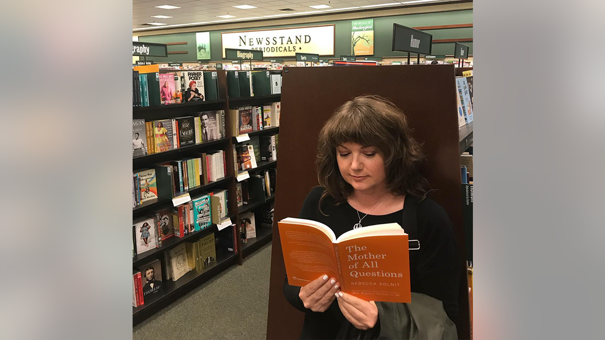 Amanda Page is shown reading "The Mother of All Questions" by Rebecca Solnit at a Barnes and Noble book store. (Amanda Page)