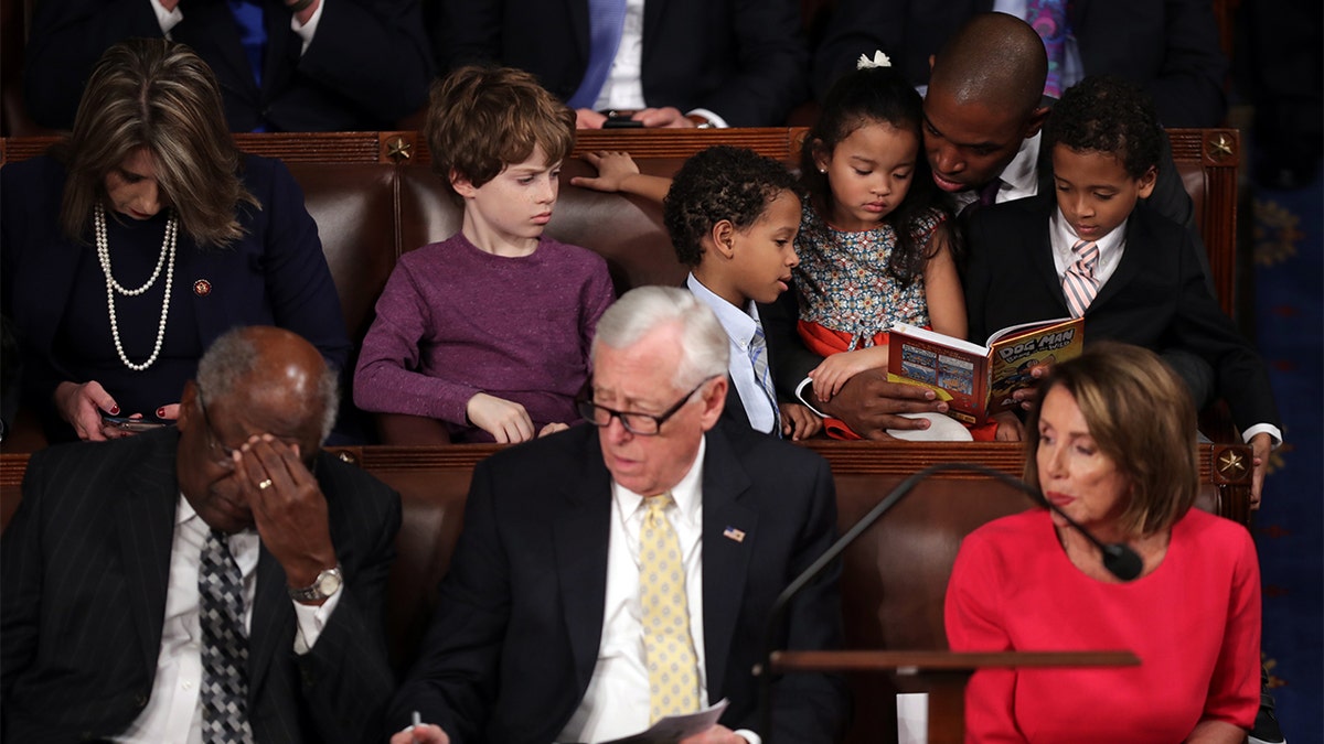 FILE - Rep-elect Antonio Delgado, D-N.Y., reads to children as (Bottom Row, L-R) House Assistant Democratic Leader Rep. James Clyburn, D-S.C., House Minority Whip Steny Hoyer, D-Md., and Speaker-designate Rep. Nancy Pelosi, D-Calif., look on during the first session of the 116th Congress at the U.S. Capitol Jan. 3, 2019 in Washington. (Photo by Chip Somodevilla/Getty Images)