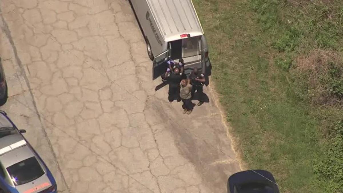 Aerial views show Atlanta police handcuffing protesters