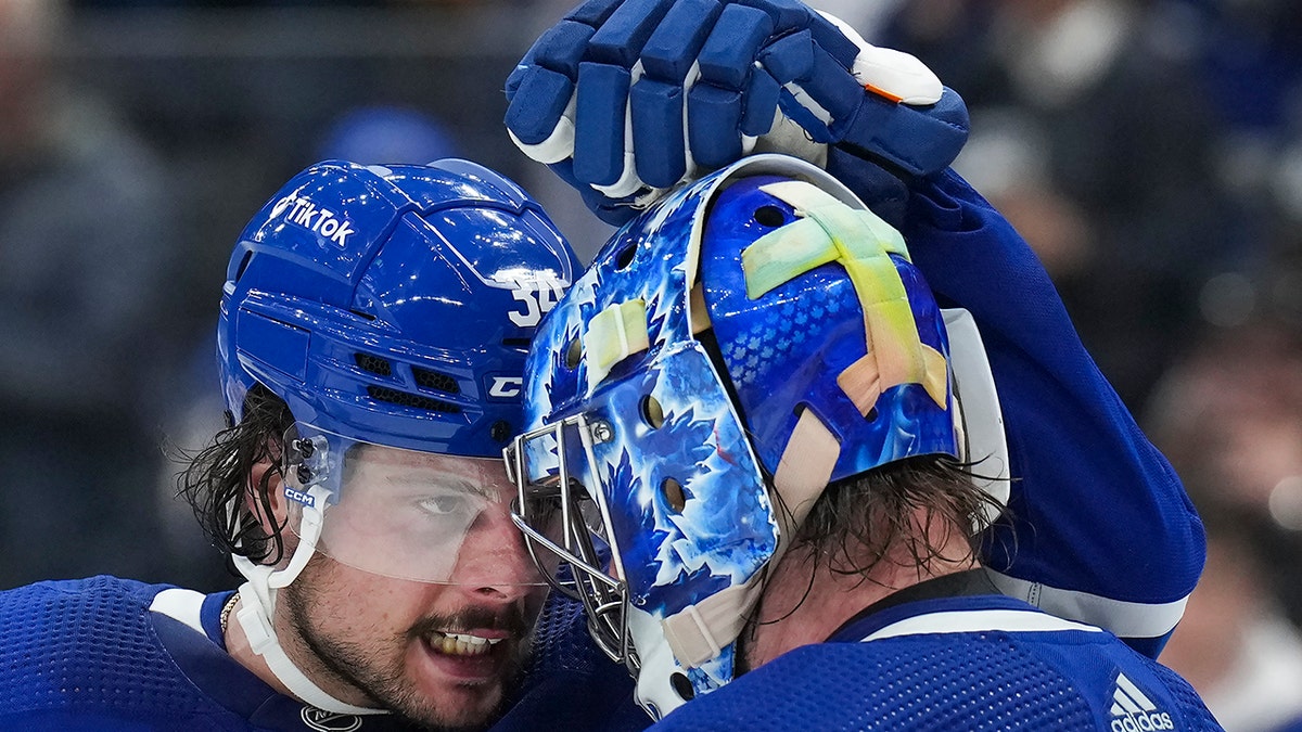 Toronto Maple Leafs forward Auston Matthews (34) celebrates with teammate Jack Campbell (36) after defeating the Tampa Bay Lightning during third period of Game 5 of an NHL hockey Stanley Cup first-round playoff series, Tuesday, May 10, 2022, in Toronto.