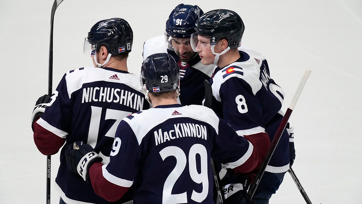 Colorado Avalanche defenseman Cale Makar, right, is congratulated by right wing Valeri Nichushkin, left, center Nathan MacKinnon, front center, and center Nazem Kadri for Makar's goal during the first period of an NHL hockey game against the Nashville Predators on Thursday, April 28, 2022, in Denver.