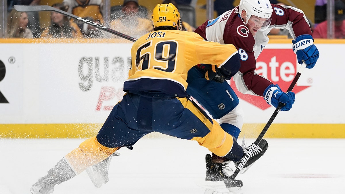 Colorado Avalanche defenseman Cale Makar (8) passes the puck past Nashville Predators' Roman Josi (59) during the first period in Game 4 of an NHL hockey first-round playoff series Monday, May 9, 2022, in Nashville, Tenn.