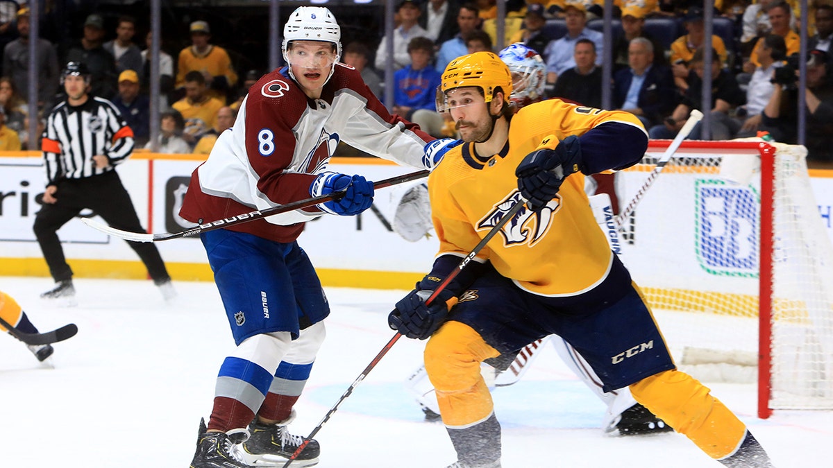 Colorado Avalanche defenseman Cale Makar (8) defends against Nashville Predators left wing Filip Forsberg (9), of Sweden, during Game 4 of the first round of the Stanley Cup Playoffs between the Nashville Predators and Colorado Avalanche, held on May 9, 2022, at Bridgestone Arena in Nashville, Tennessee.