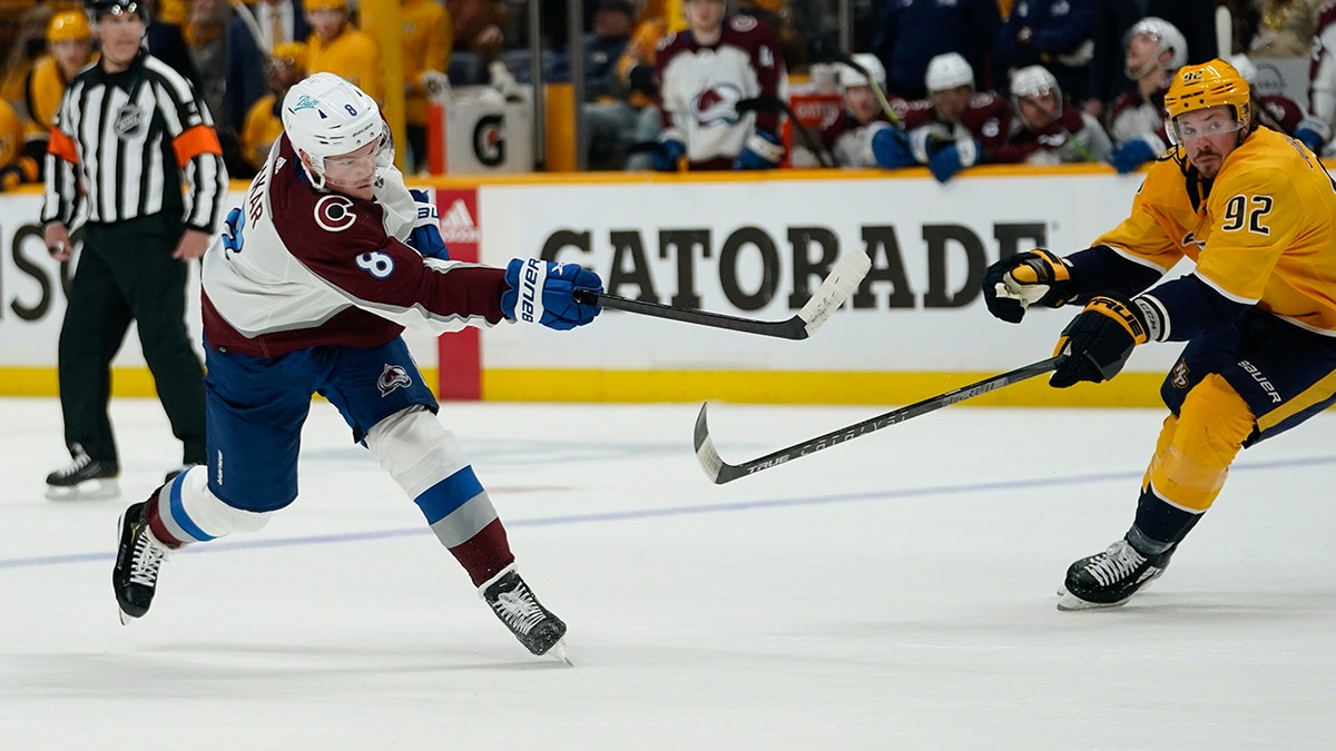 Cale Makar #8 of the Colorado Avalanche takes a shot on goal as Ryan Johansen #92 of the Nashville Predators defends during the second period of Game Four of the First Round of the 2022 Stanley Cup Playoffs at Bridgestone Arena on May 09, 2022 in Nashville, Tennessee.