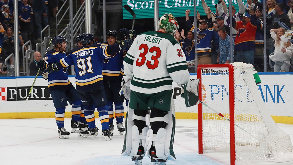 St. Louis Blues celebrate after a goal against Minnesota Wild goalie Cam Talbot during the second period in Game 6 of an NHL hockey Stanley Cup first-round playoff series Thursday, May 12, 2022, in St. Louis. 