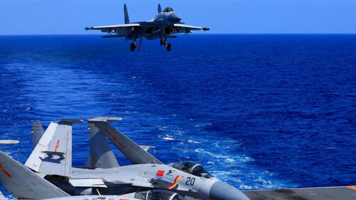 A carrier-based J-15 fighter jet prepares to land on the Chinese navy's Liaoning aircraft-carrier