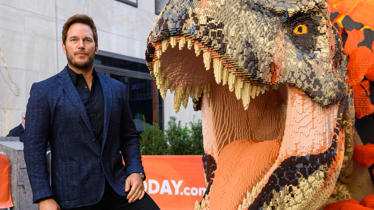 Chris Pratt poses near a dinosaur ahead of "Jurassic World Dominion" premiere