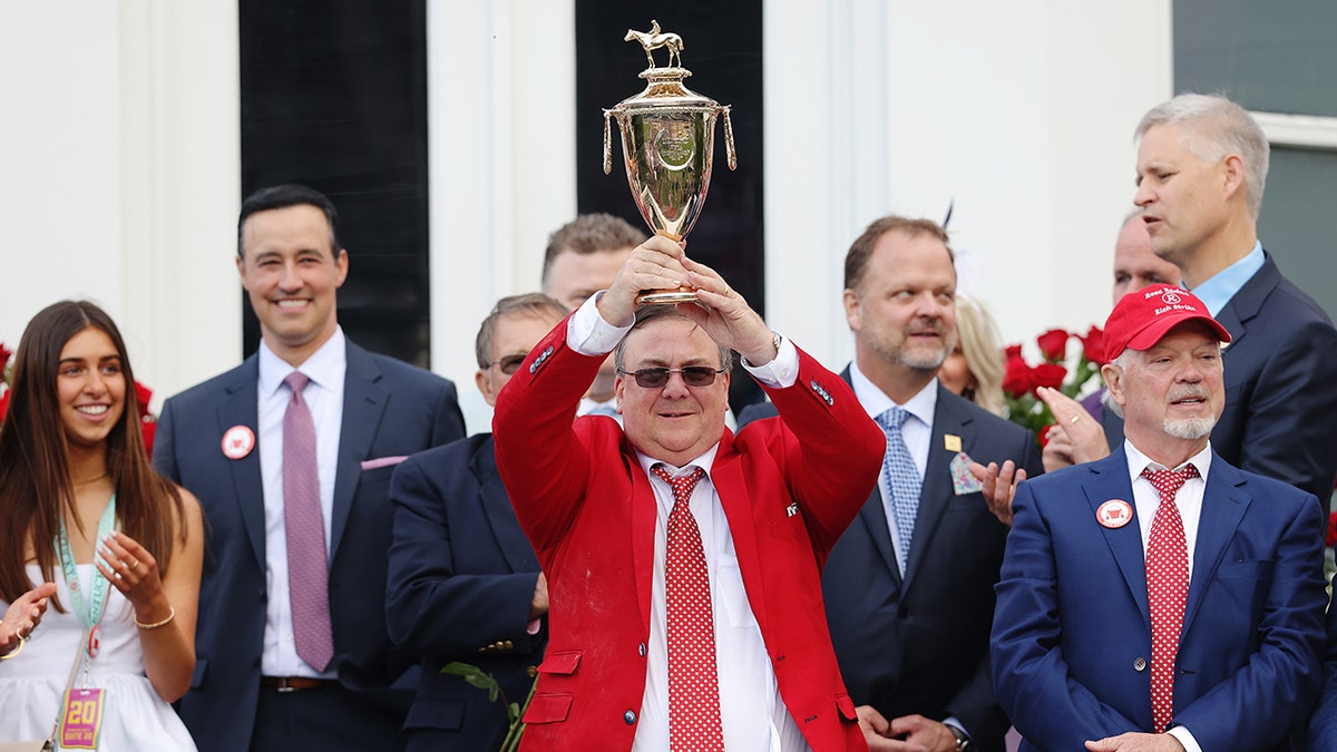 Trainer Eric Reed holds the trophy after Rich Strike won the 148th running of the Kentucky Derby at Churchill Downs on May 07, 2022 in Louisville, Kentucky.