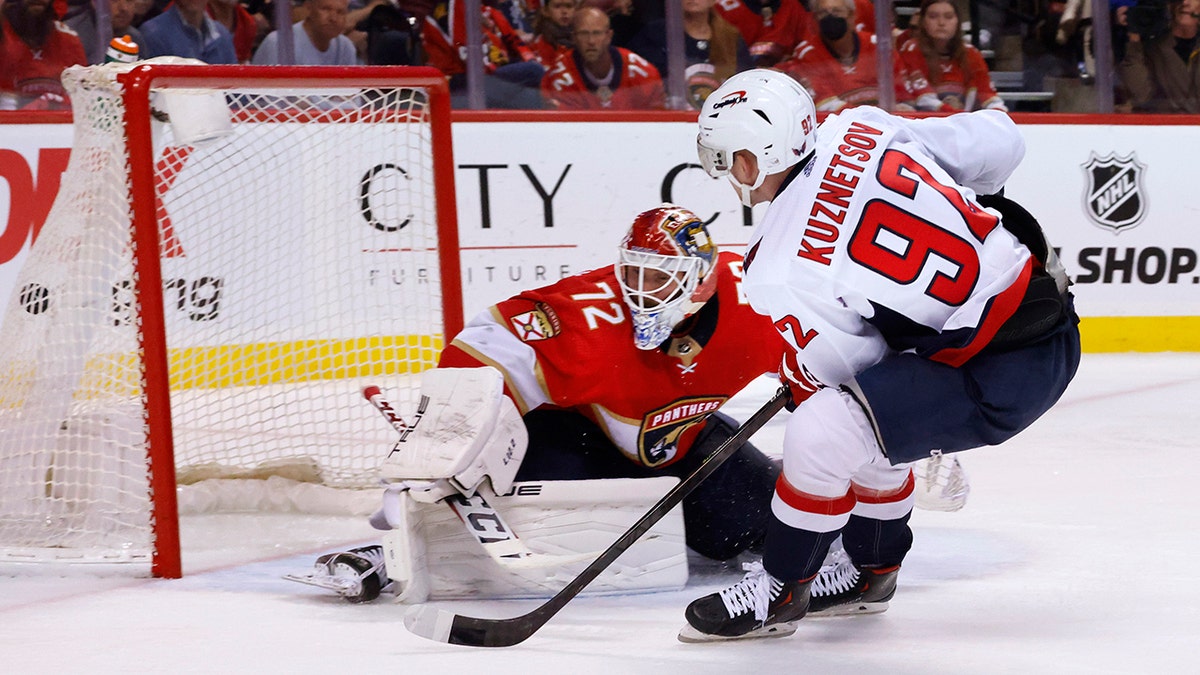 Washington Capitals center Evgeny Kuznetsov (92) scores against Florida Panthers goaltender Sergei Bobrovsky (72) during the third period of Game 1 of an NHL hockey first-round playoff series Tuesday, May 3, 2022, in Sunrise, Fla. 