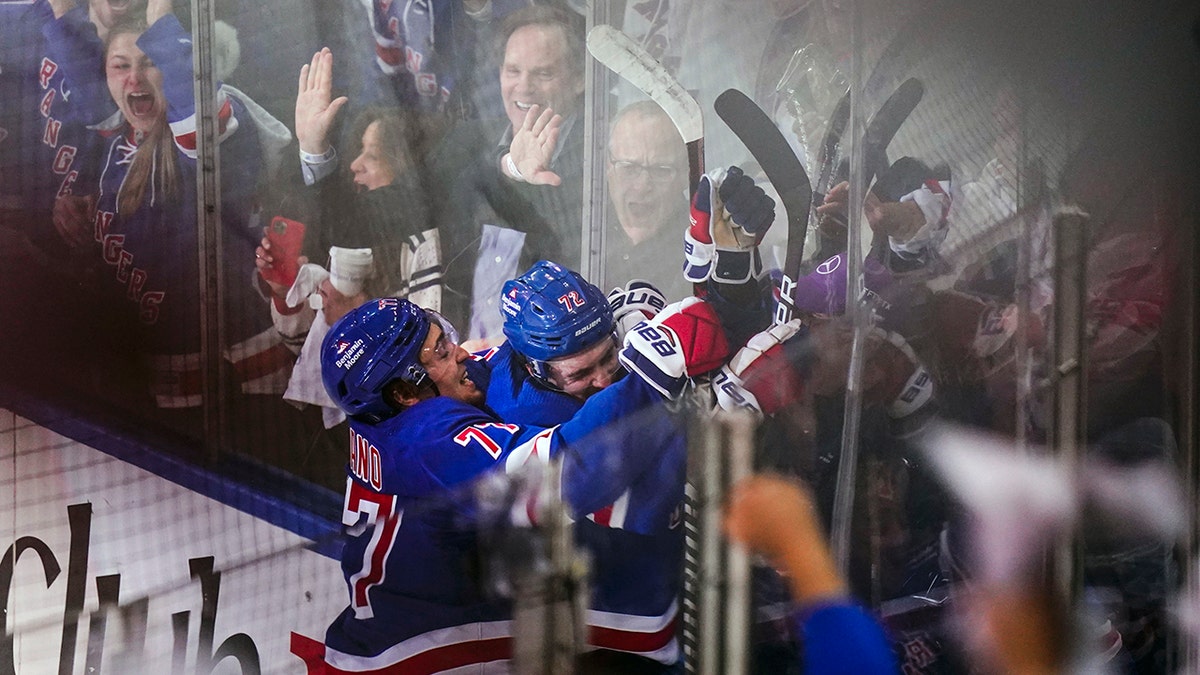 New York Rangers' Frank Vatrano (77) celebrates with Filip Chytil (72) after Chytil scored a goal during the third period of Game 5 of an NHL hockey Stanley Cup first-round playoff series against the Pittsburgh Penguins Wednesday, May 11, 2022, in New York. The Rangers won 5-3.