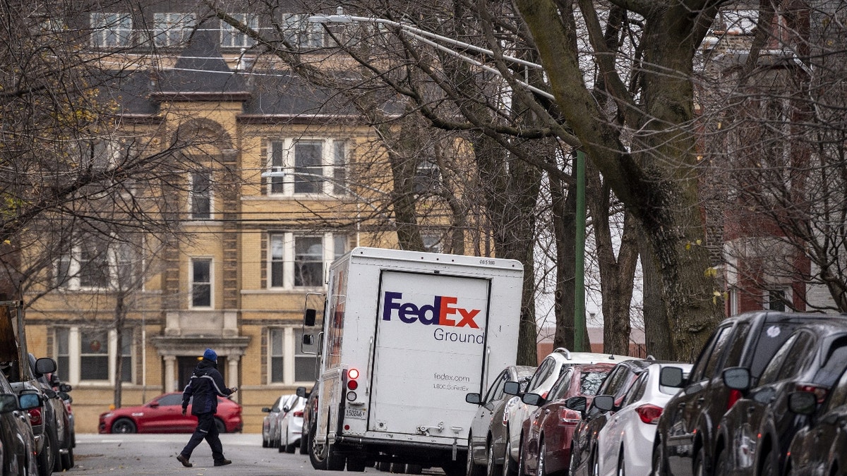 A driver returns to a FedEx Corp. Ground truck in the Lincoln Park neighborhood of Chicago, Illinois, U.S., on Monday, Nov. 30, 2020. 